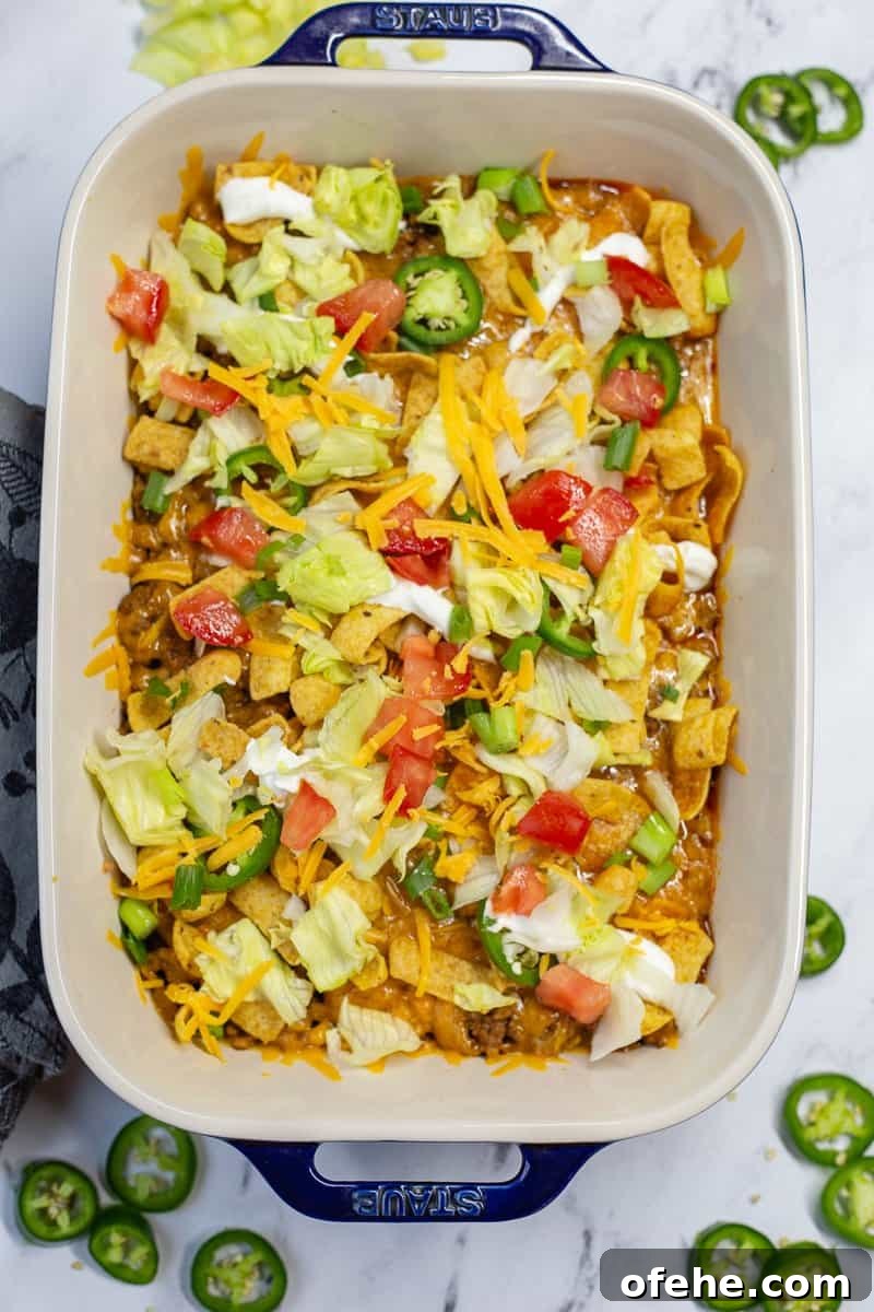 Crunchy Frito Taco Casserole with Melted Cheese and Beef 2 Baked Walking Taco Casserole in baking dish.