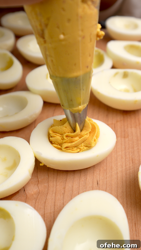 Deviled Eggs with Mi Goreng Instant Noodle Flavor 8 Piping deviled egg mixture into egg whites