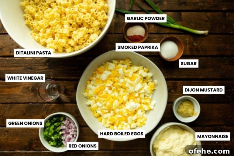 Deviled Egg Pasta Salad for Summer Gatherings 3 a photo of all the ingredients for deviled egg pasta salad in different bowls on a table