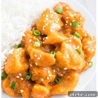 Slow Cooker Orange Chicken Recipe with Sticky Citrus Sauce 6 Easy Slow Cooker Orange Chicken in White Dish With Rice.