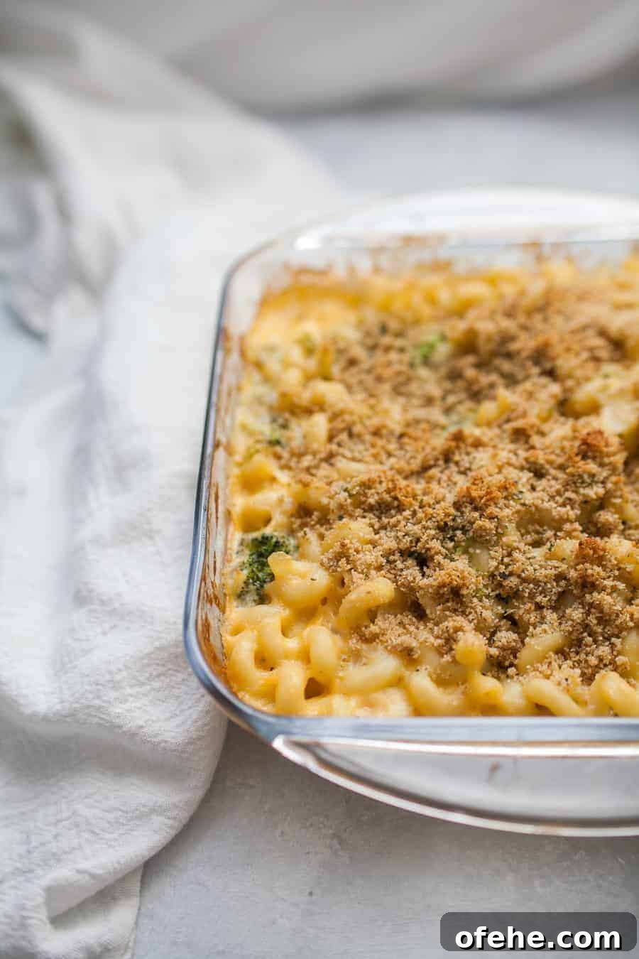 Homemade macaroni and cheese baked in a glass dish.