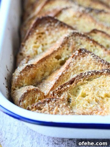 Close-up of French toast casserole in a white pan.