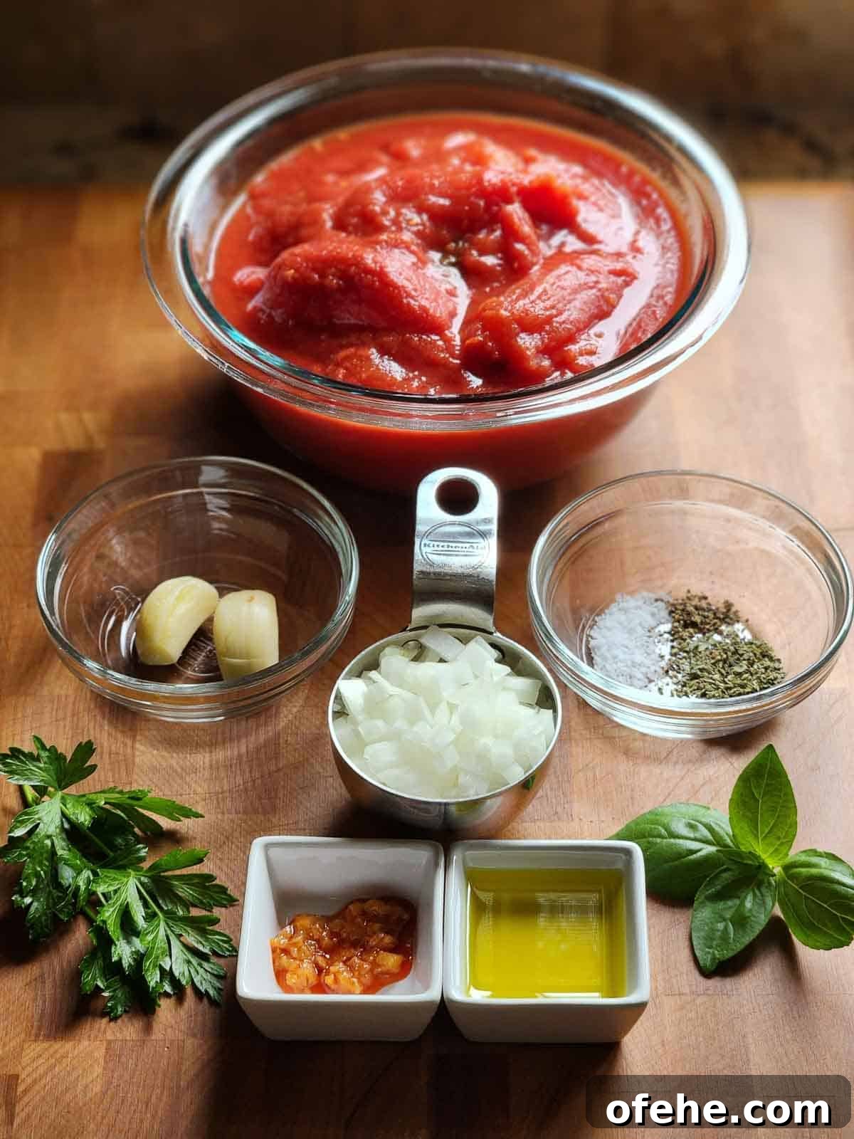 Poached Eggs in Spicy Tomato Sauce (Eggs in Purgatory) 3 Ingredients laid out for making eggs in purgatory.