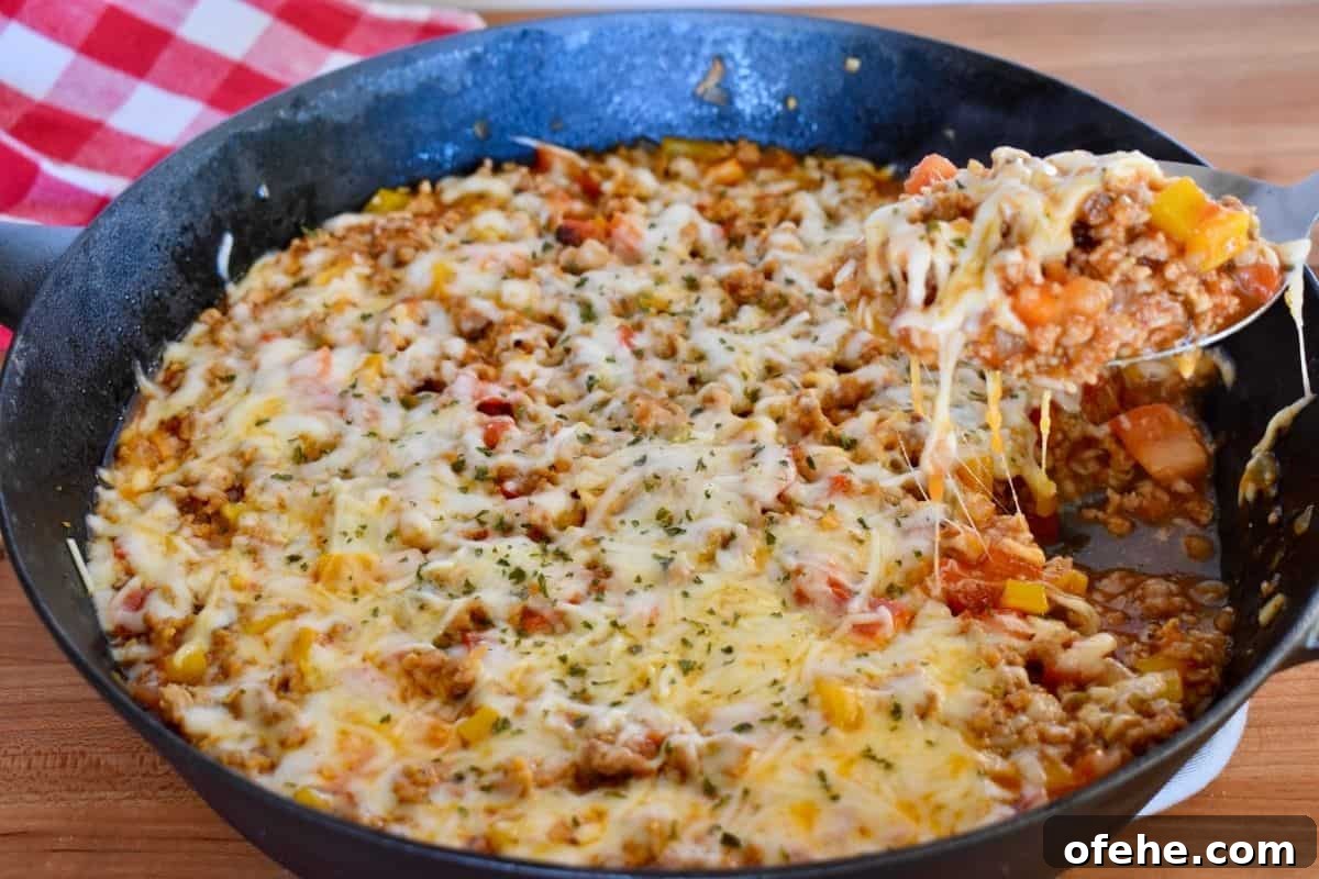 One-Pan Stuffed Pepper Skillet with Ground Beef and Rice 11 Photo of Stuffed Peppers Skillet with a spoon scooping out some of the recipe.