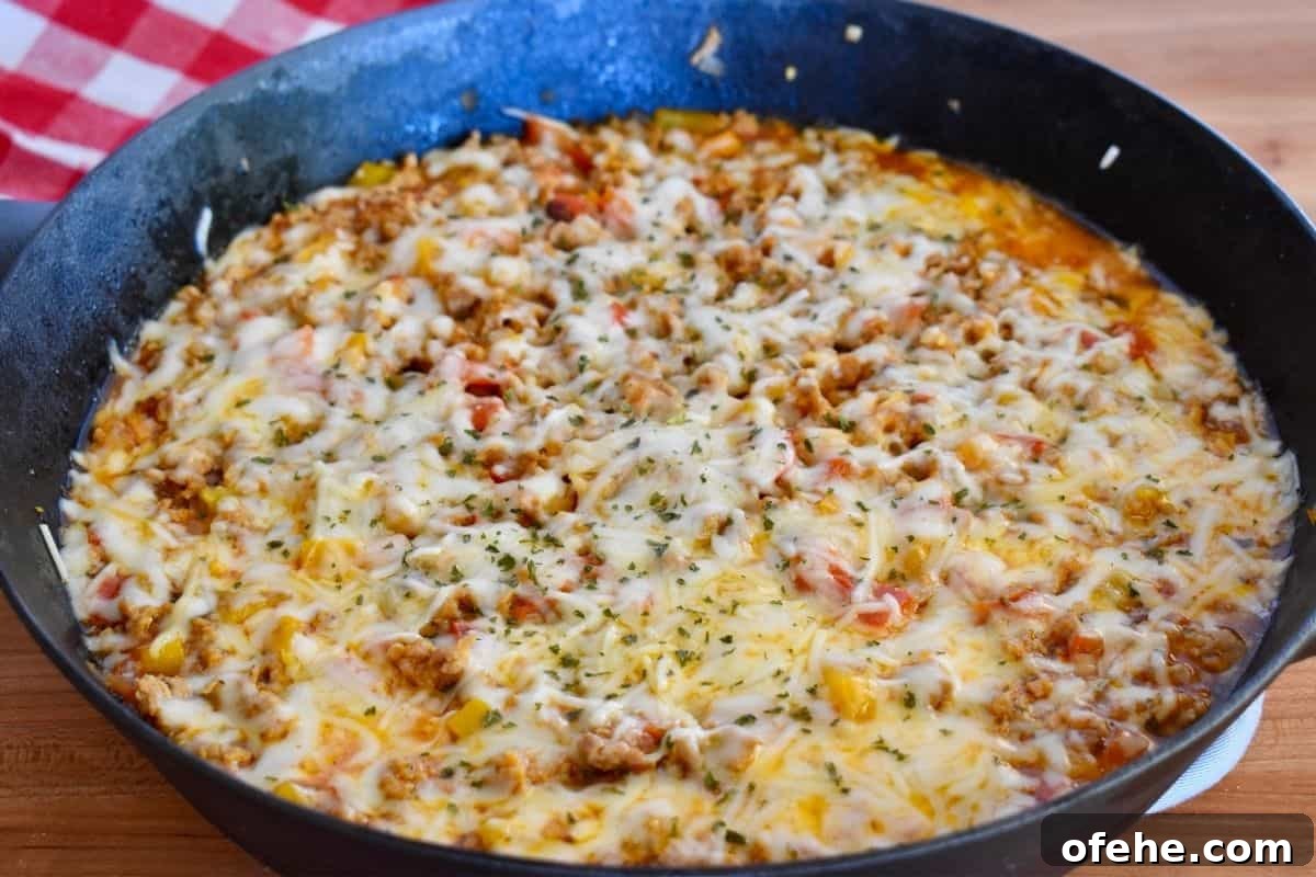 One-Pan Stuffed Pepper Skillet with Ground Beef and Rice 6 Unstuffed peppers with Italian sausage recipe in a large black cast iron skillet.
