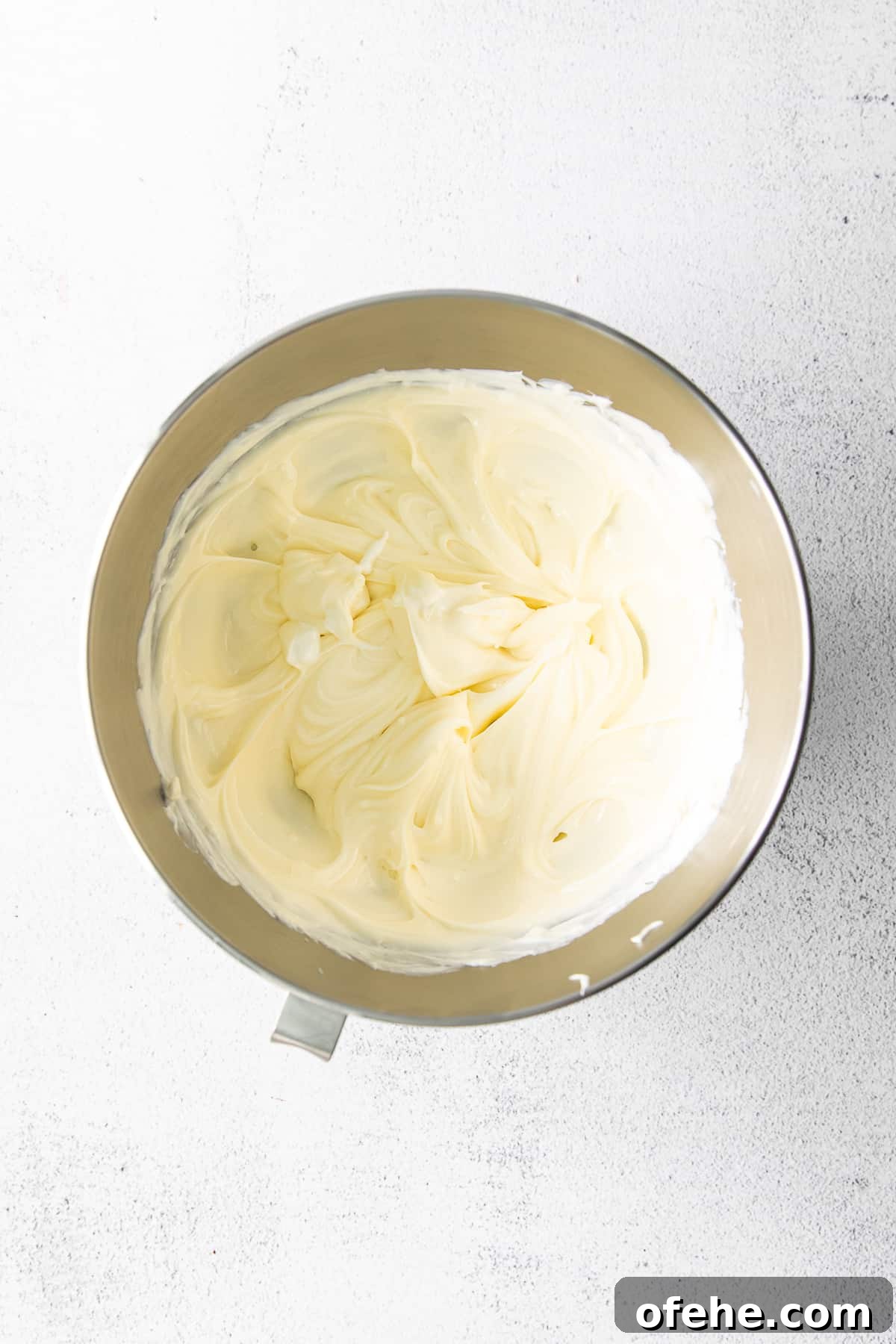 cream cheese and sugar whipped in a bowl
