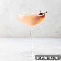 Sour Cherry French 75 Cocktail for Seasonal Entertaining 7 French 75 Sour Cherry Cocktail in a coupe glass garnished with homemade maraschino cherries