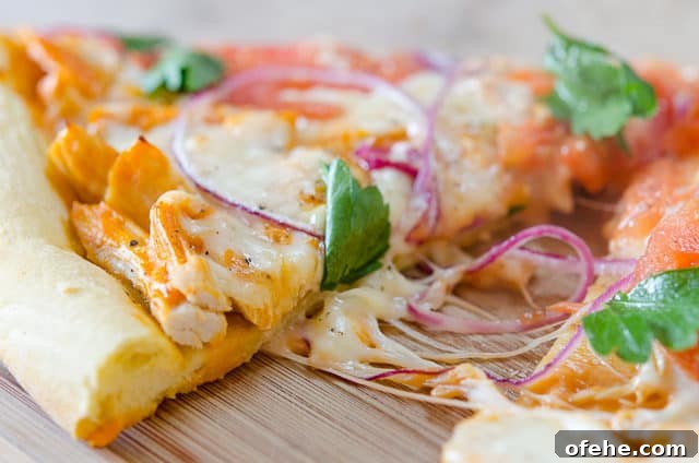 Spicy Buffalo Chicken Pizza Recipe for Game Day and Parties 3 Homemade Buffalo Chicken Pizza Slice on Board with Gooey Cheese