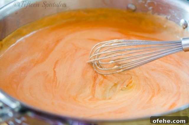 Frank's Hot Sauce Bechamel Buffalo Chicken Pizza | fifteenspatulas.com Frank's Buffalo Sauce Bechamel in Pan with Whisk