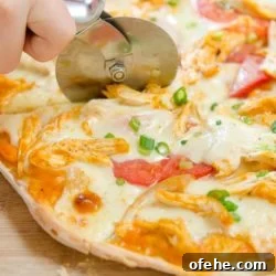 Spicy Buffalo Chicken Pizza Recipe for Game Day and Parties 4 Buffalo Chicken Pizza Cut with a Pizza Cutter on Wooden Board