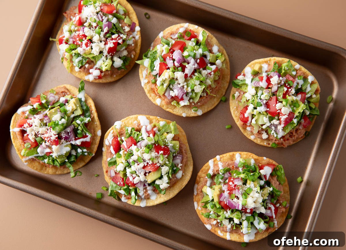 Crispy Mini Tostadas: Party-Ready Bite-Sized Tacos 7 mini tostadas with refried beans, cheese, lettuce, tomatoes, red onions, avocado and sour cream