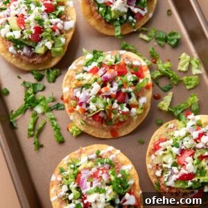 Crispy Mini Tostadas: Party-Ready Bite-Sized Tacos 8 mini tostadas with refried beans, cheese, lettuce, tomatoes, red onions, avocado, sour cream, and hot sauce