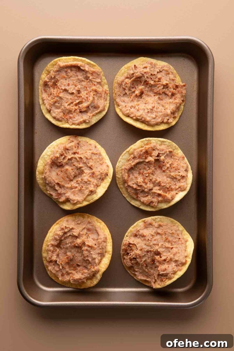 Crispy Mini Tostadas: Party-Ready Bite-Sized Tacos 3 seasoned vegetarian refried beans on crispy corn tostada shells