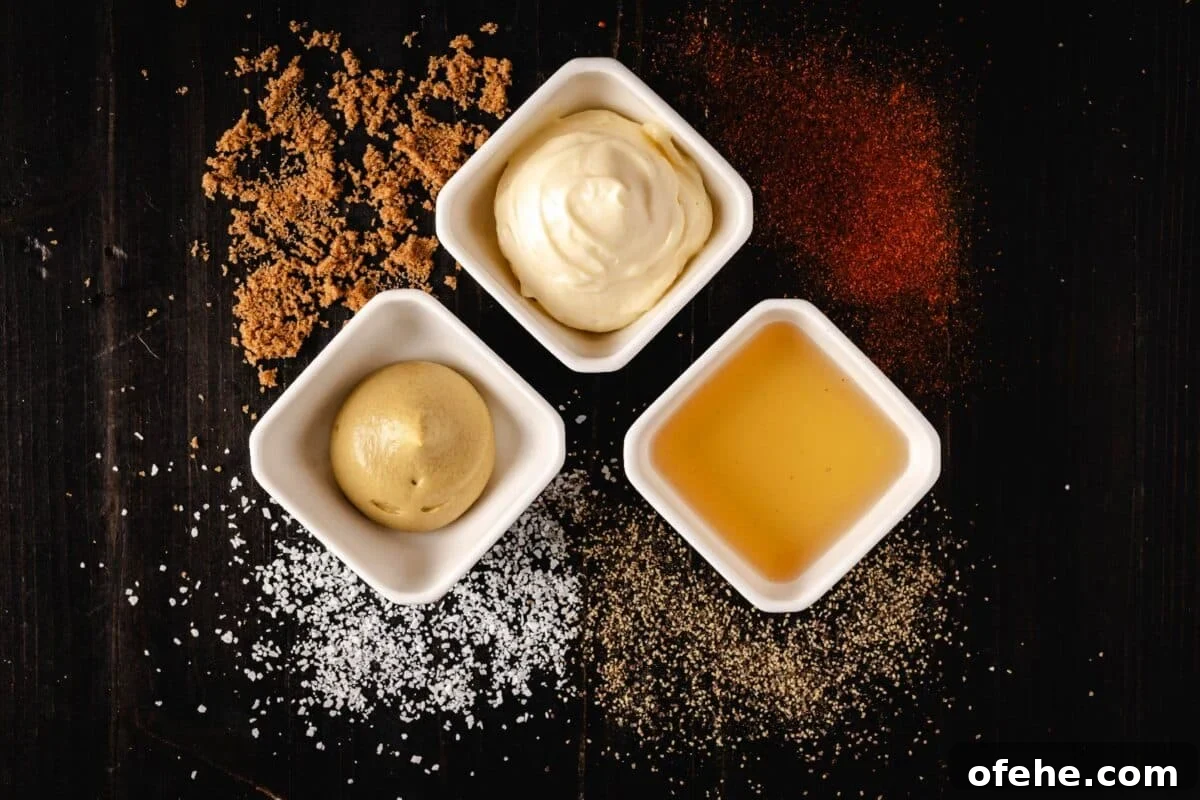 Crispy Grilled Chicken Cordon Bleu Recipe with Ham & Melty Cheese 5 Mayo, mustard, and vinegar in white bowls next to piles of salt, pepper, brown sugar, and cayenne pepper.