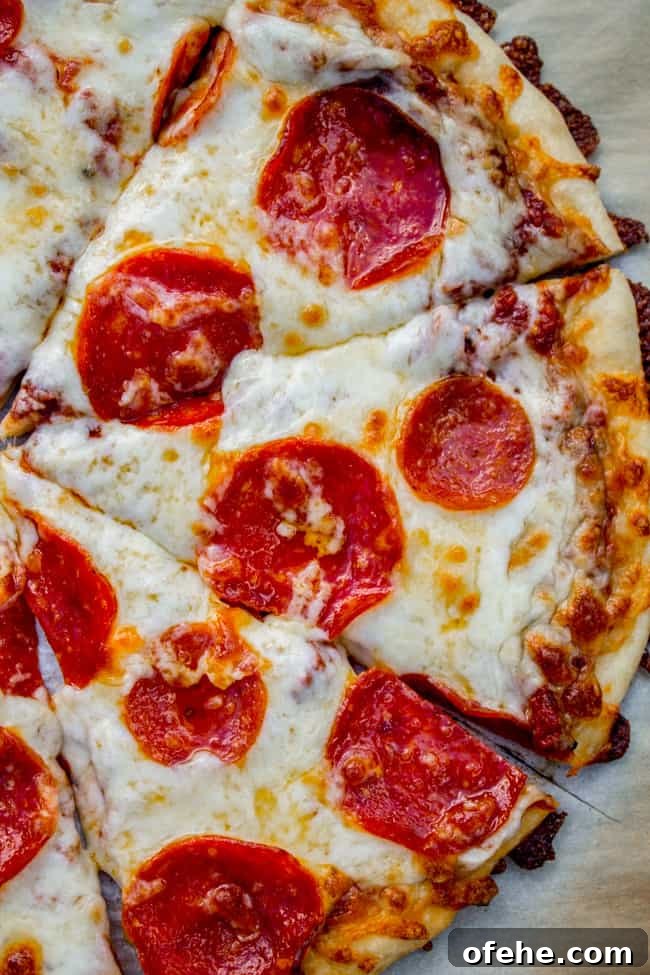 a homemade pepperoni pizza cut in slices.