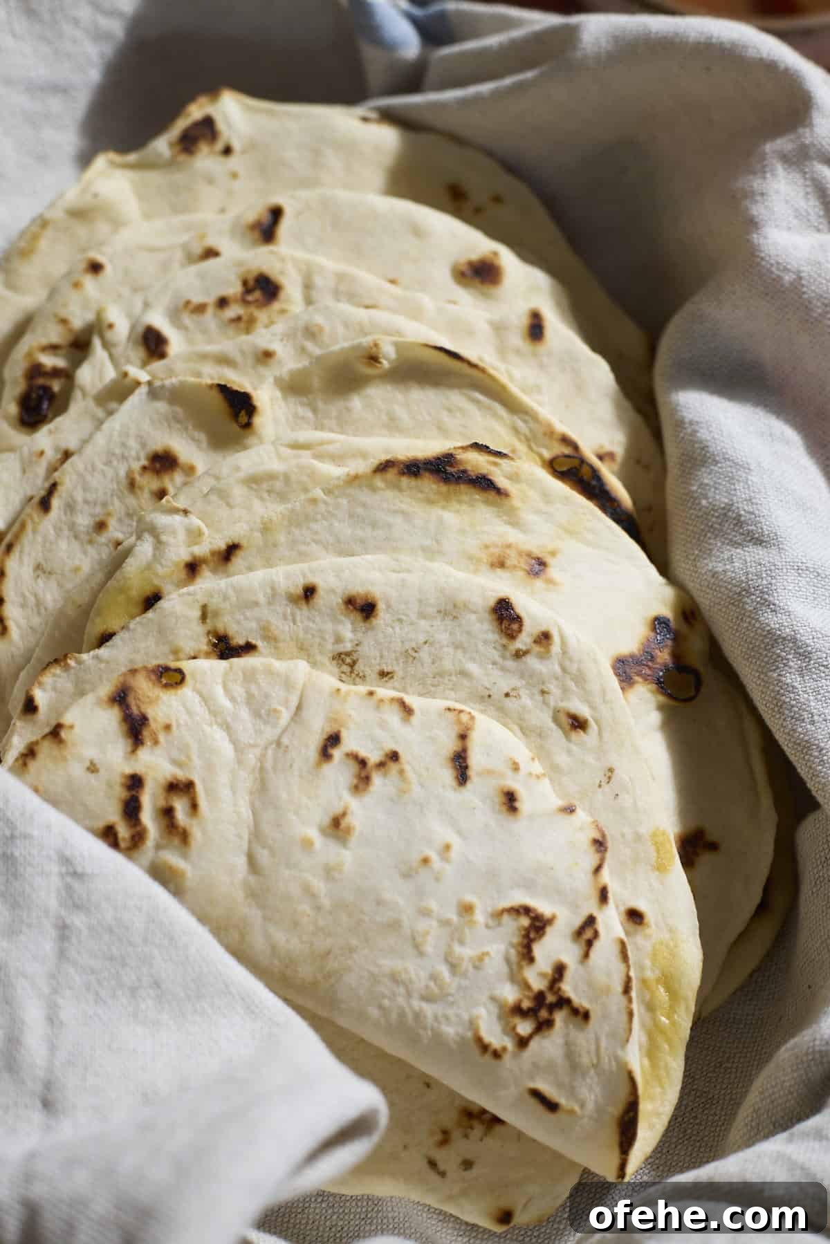 Sourdough Discard Tortillas wrapped in a kitchen towel.