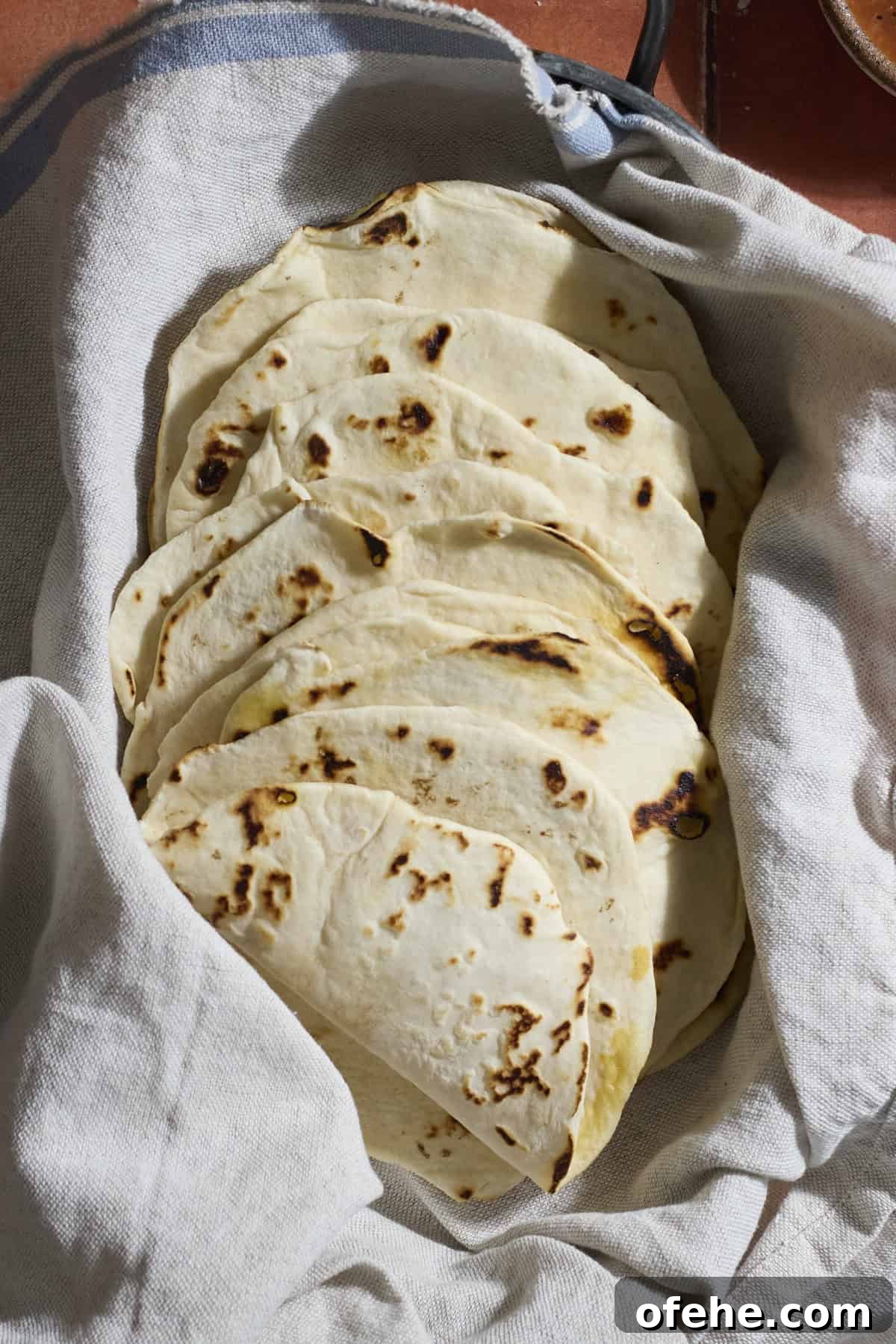 Sourdough Discard Tortillas wrapped in a kitchen towel.