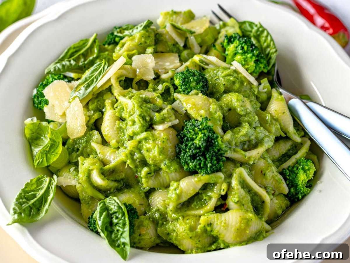 30-Minute Dinners We Cook on Busy Weeknights 8 Step 4 Bowl of smashed broccoli pasta topped with basil leaves and shaved parmesan.