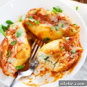 5 Cheese Stuffed Shells Recipe is an easy pasta recipe perfect for family dinner. Classic Italian flavors featuring five different cheeses, garlic, spinach, and red sauce this 5 Cheese Stuffed Shell Recipe is creamy, cheesy, and satisfying. Perfect for a meatless family dinner recipe!