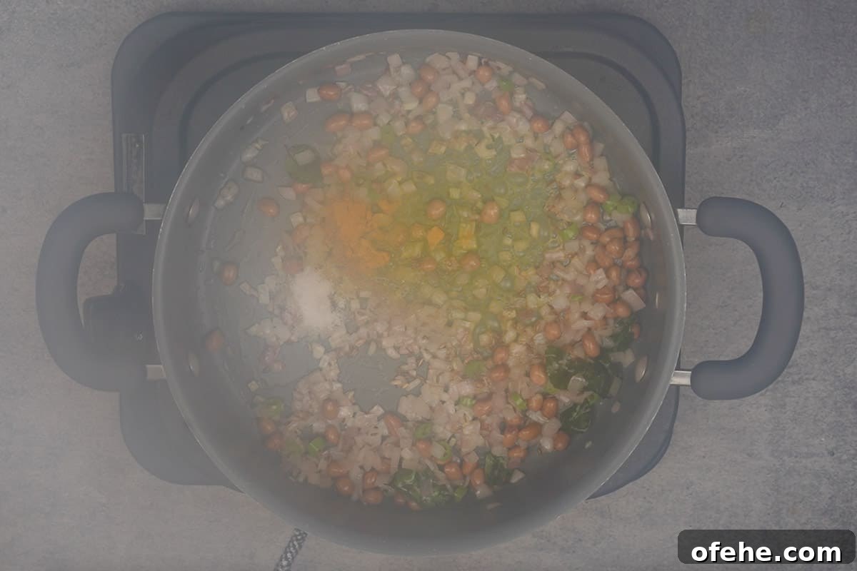 Millet Poha: Flavorful Wholesome Breakfast Recipe for Busy Mornings 9 Lime juice, turmeric powder, salt and sugar added to the pan.