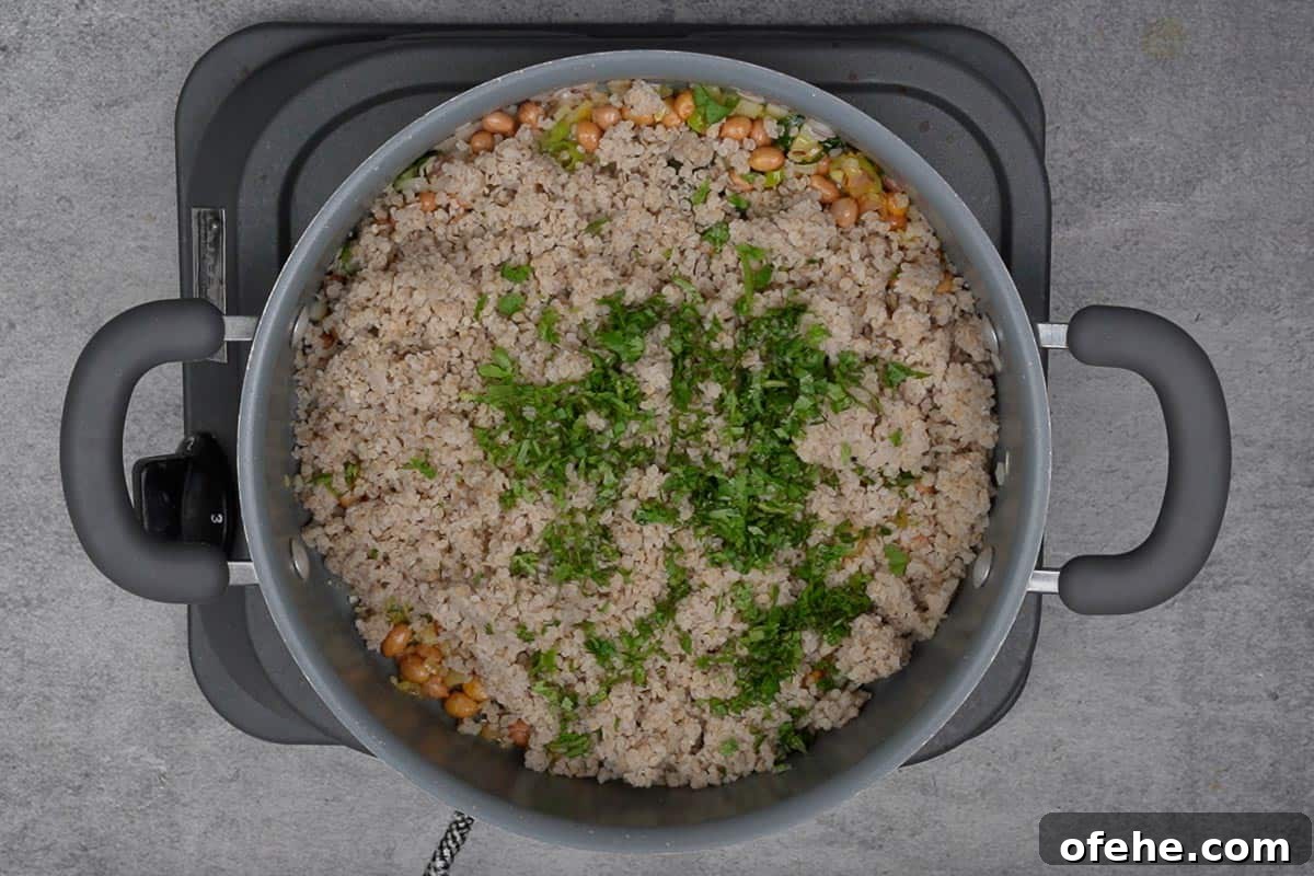 Millet Poha: Flavorful Wholesome Breakfast Recipe for Busy Mornings 10 Soaked poha added to the pan.
