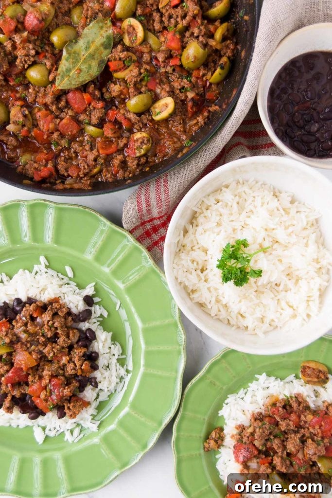 Authentic Brazilian Picadillo (Picadinho) Recipe for Dinner 13 Green bowls hold servings of Brazilian picadillo over rice with beans and sit next to a skillet holding more picadillo and bowls holding rice and beans