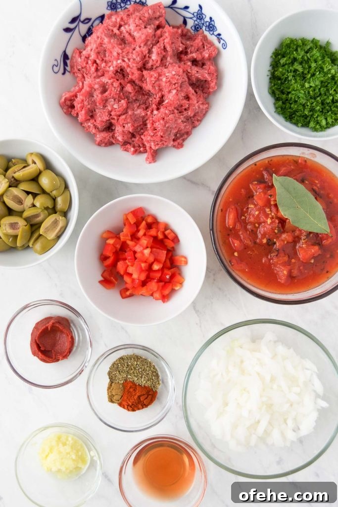 Authentic Brazilian Picadillo (Picadinho) Recipe for Dinner 4 Ground beef, green olives, bell pepper, onion and other picadillo recipe ingredients in bowls from above