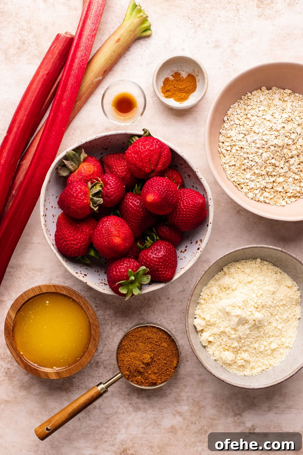 Gluten-Free Strawberry Rhubarb Crisp Recipe for Summer Dessert 3 ingredients for gluten free strawberry rhubarb crisp arranged on a tan colored background.