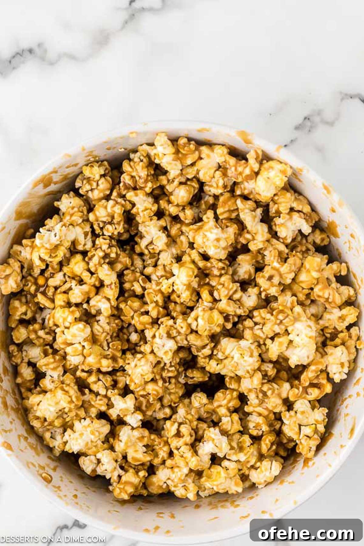 Ultimate Homemade Caramel Popcorn Recipe You’ll Love 6 Popcorn in bowl coated in caramel.