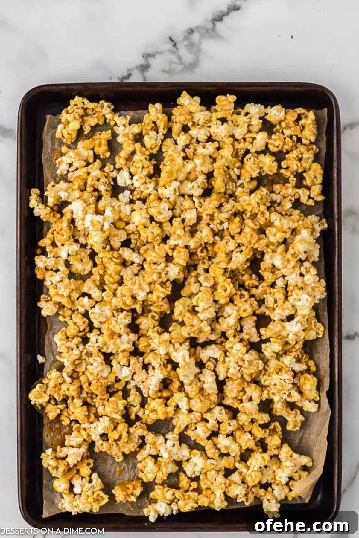 Ultimate Homemade Caramel Popcorn Recipe You’ll Love 7 Popcorn on baking sheet.