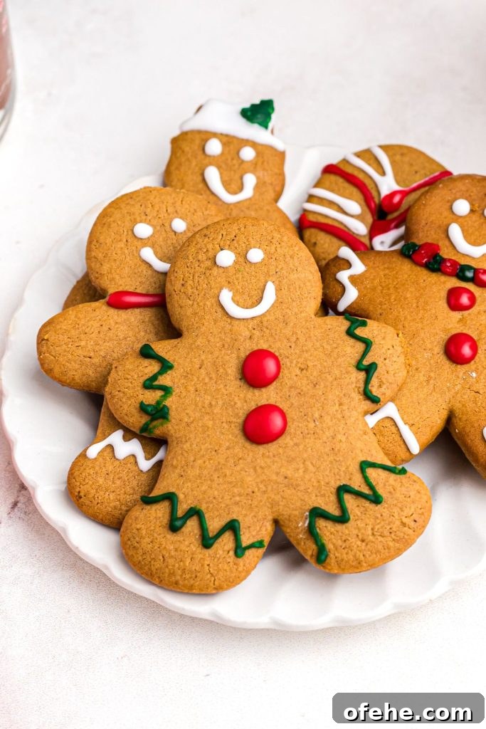 Chewy Air Fryer Gingerbread Cookies Recipe 12 Golden gingerbread man cookie on a white plate