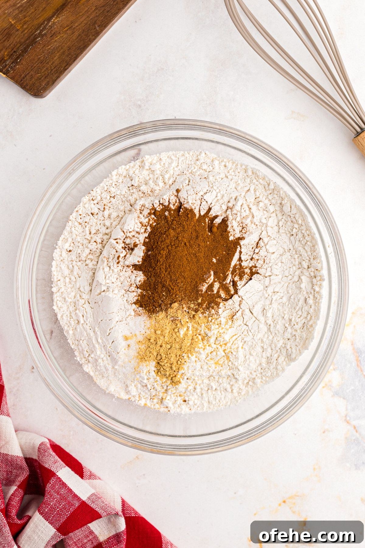 Chewy Air Fryer Gingerbread Cookies Recipe 5 flour, cinnamon, and other seasonings being mixed in a clear bowl