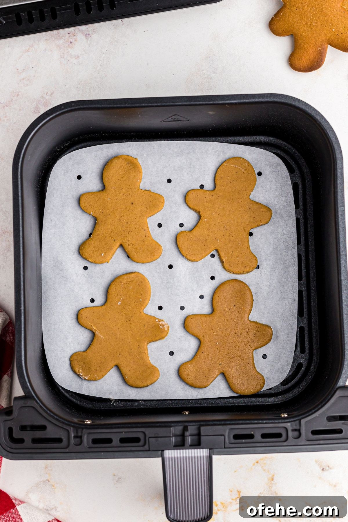 Chewy Air Fryer Gingerbread Cookies Recipe 9 Uncooked gingerbread men in an air fryer basket