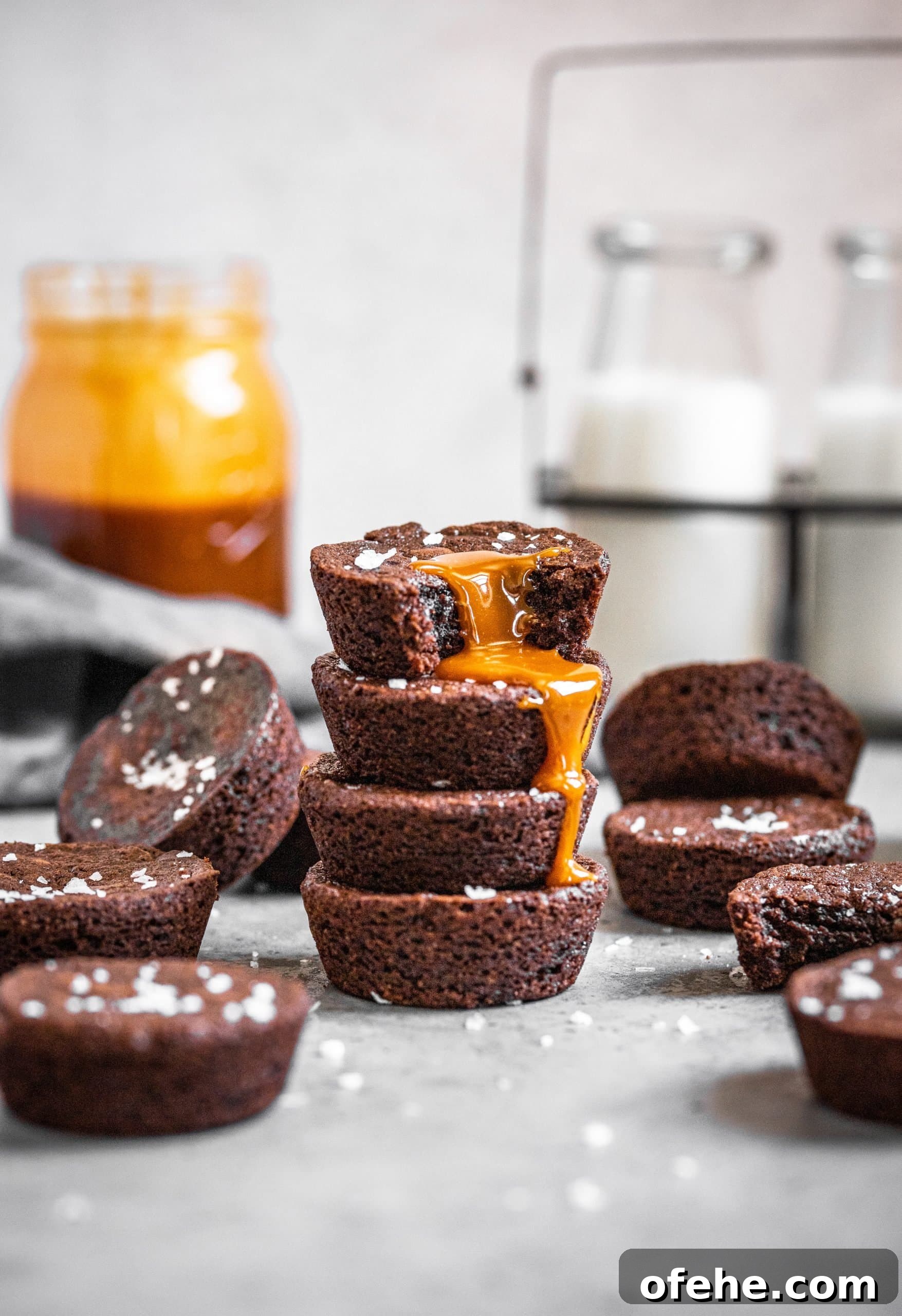 Salted Caramel Brownie Bites in a Muffin Tin 2 A stack of Muffin Tin Brownie Bites with Salted Caramel Sauce dripping down the side