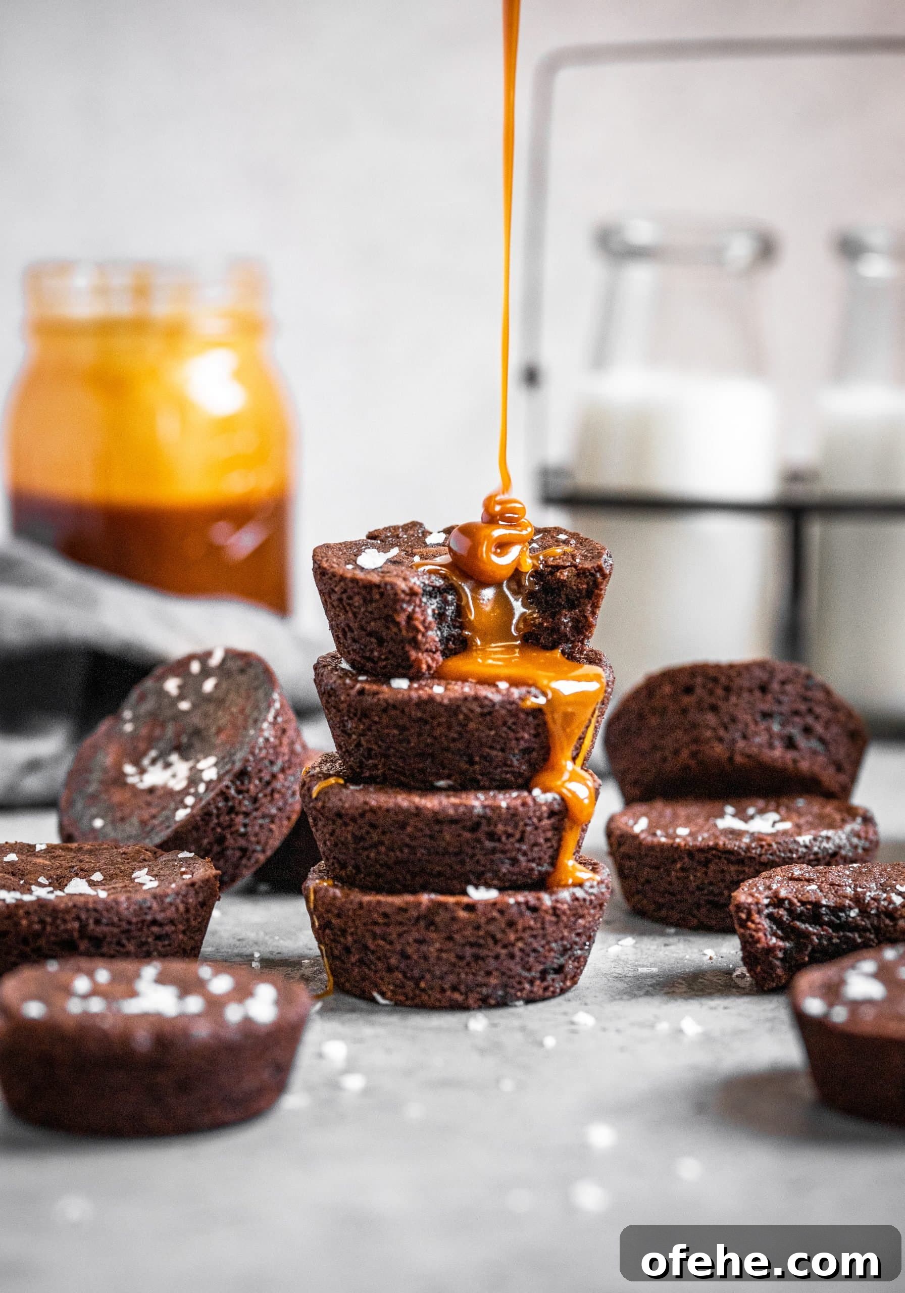 Salted Caramel Brownie Bites in a Muffin Tin 4 Salted caramel being poured on top of a stack of brownie bites
