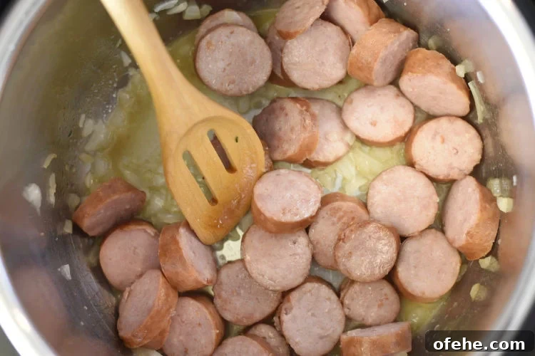 Instant Pot Kielbasa with Savory Rice Bowl 3 brown kielbasa and onions in the pressure cooker