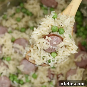 Instant Pot Kielbasa with Savory Rice Bowl 8 kielbasa with rice and peas on wooden spoon in the pressure cooker