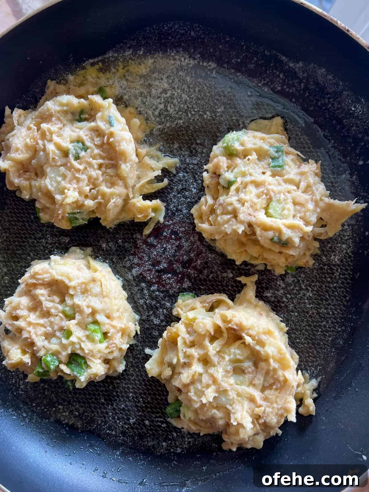 Gluten-Free Potato Pancakes with Optional Whole30 Version 12 The potato pancake batter on a frying pan.