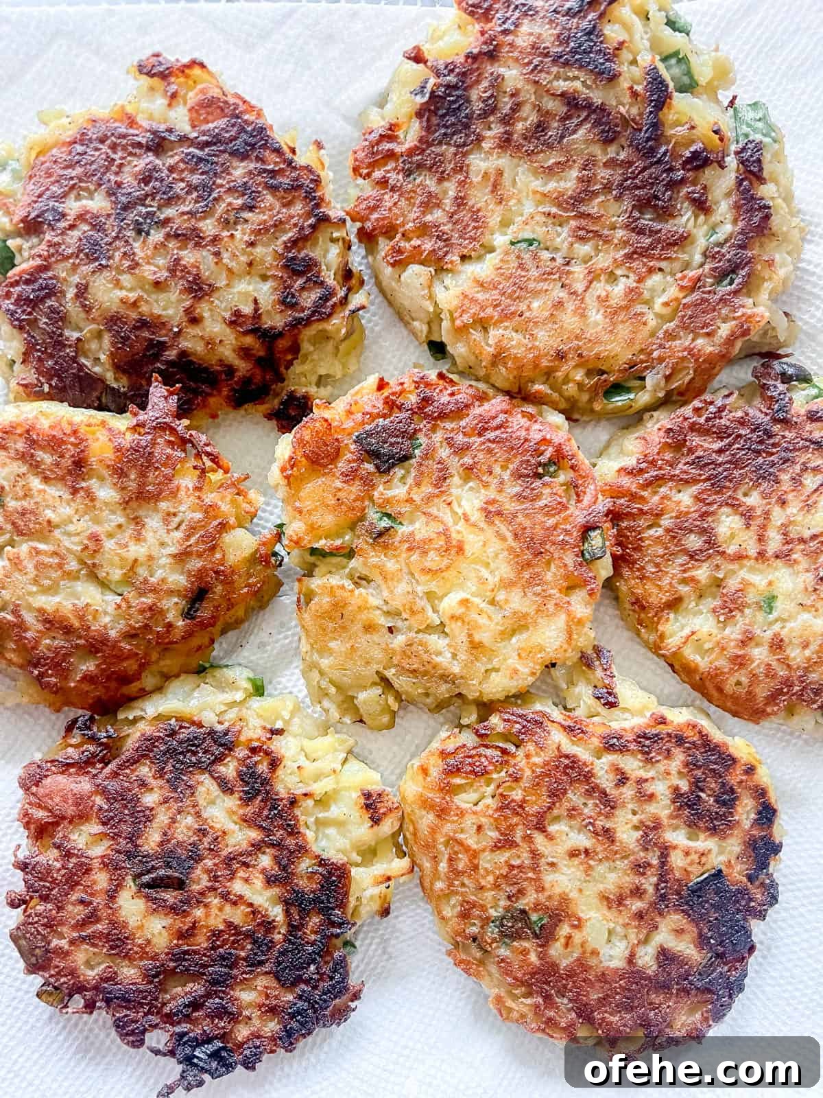Gluten-Free Potato Pancakes with Optional Whole30 Version 14 Cooked healthy potato pancakes on a paper towel.