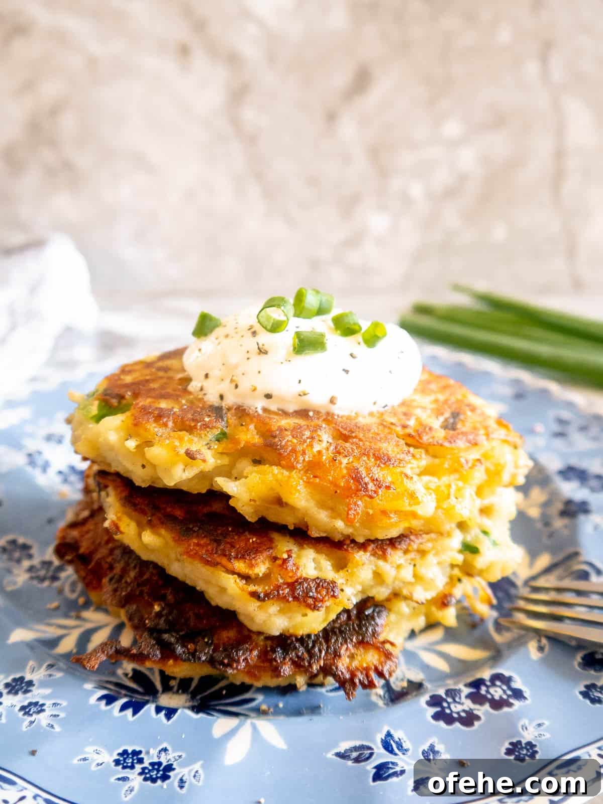 Gluten-Free Potato Pancakes with Optional Whole30 Version 15 Whole30 potato pancakes on a plate, stacked on top of each other.