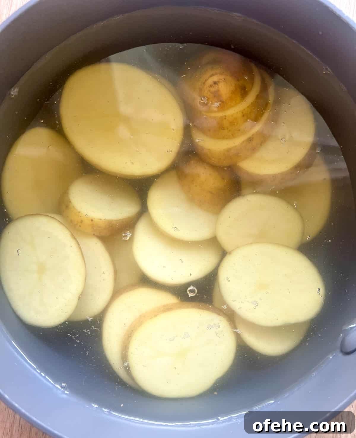Gluten-Free Potato Pancakes with Optional Whole30 Version 4 Potatoes in a pan with water before boiling.