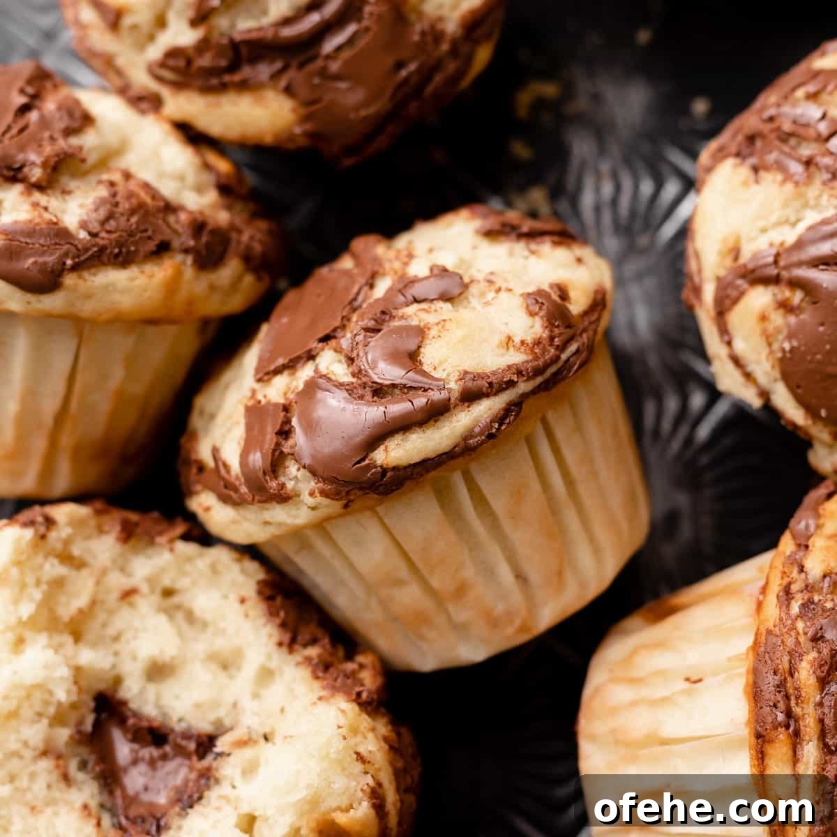Chocolate Hazelnut Banana Muffins — Moist & Gooey Recipe 11 banana nutella muffin with nutella swirled into the top.