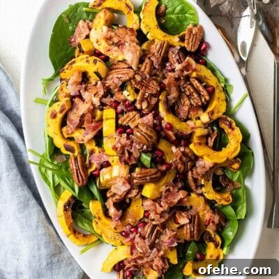 A close up look at a spinach salad with bacon dressing.
