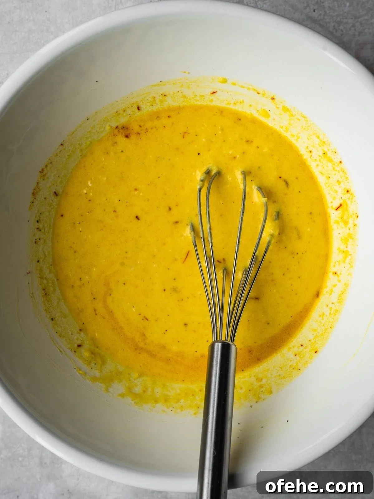 Persian Saffron Joojeh Kabob Recipe — Grilled Chicken Kabab 5 A bowl with saffron infusion, yogurt, turmeric, garlic, minced onion and olive oil.