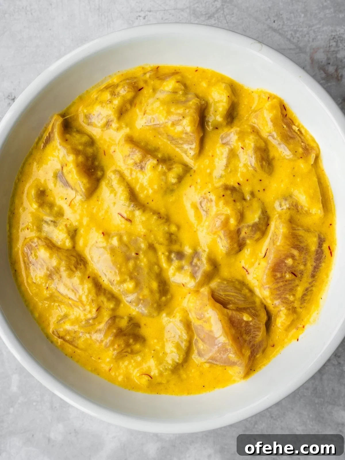 Persian Saffron Joojeh Kabob Recipe — Grilled Chicken Kabab 6 A bowl with chicken cubes marinating in the Joojeh kabob marinade.
