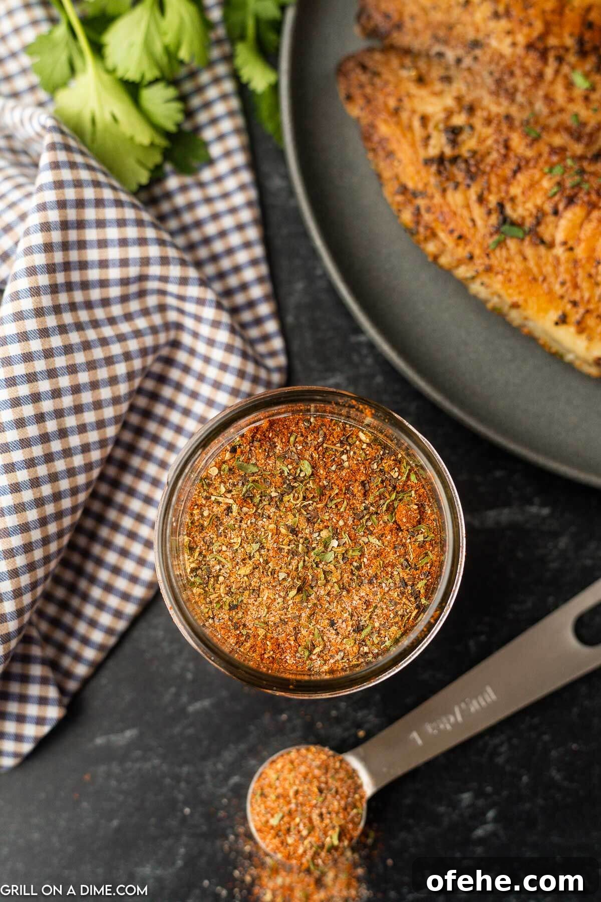 Homemade Blackened Seasoning Blend for Perfect Cajun Flavor 6 Blackened Seasoning in a jar with a teaspoon
