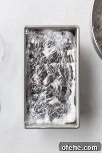 No-Bake Icebox Cake Recipe for Creamy Layered Dessert 8 Ice box cake wrapped in plastic, ready to be chilled.