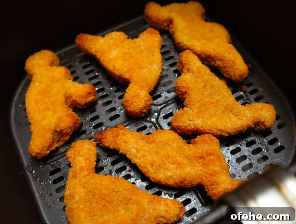 Crispy Dino Nuggets in the Air Fryer: Quick Family Snack 5 Dino nuggets in Air fryer basket