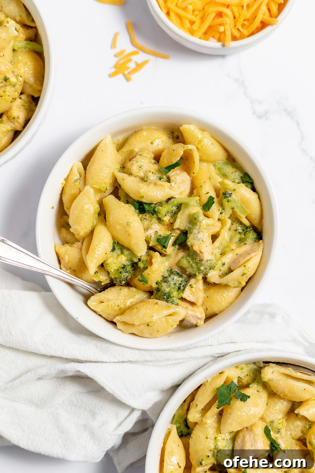 Serving of chicken and broccoli pasta in a white bowl.