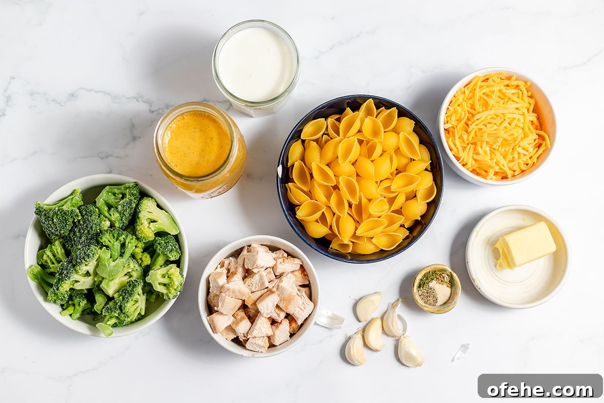 Ingredients to make chicken broccoli pasta set out on the counter.